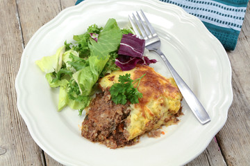 shepherd's pie with salad on a plate