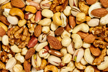 Background of mixed nuts (walnuts, pistachio, almond, peanut, cashew, hazelnut). Healthy eating concept