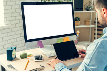 Businessman looking at computer monitor during working day in office