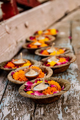 Candles and flowers on wooden boat