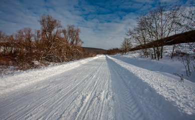 Fototapeta na wymiar Empty snow covered road in winter landscape
