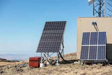 Fotobehang Blocks of solar panels to provide power for a cellular tower at a remote location, Steens mountains, Oregon © Dmitry
