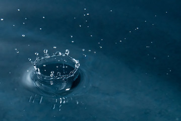 Beautiful splash of water drop on water surface, macro photo