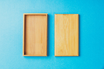 empty wooden box on blue background, top view, mock up, empty space for text