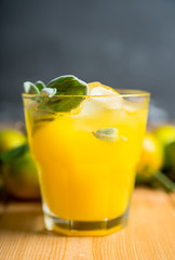 Sweet old-fashioned cocktail with orange and sage. Selective focus. Shallow depth of field.