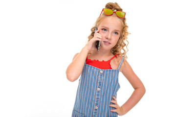 Picture of happy child with fair red curly hair talking on the phone with fimily isolated on white background