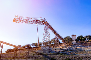 Big crane in the countryside with a blue sky
