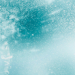 Obraz na płótnie Canvas Winter shiny snowflakes blurred background in white blue colors