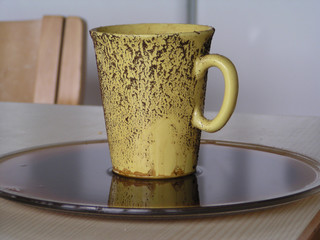 A yellow cup with run away coffee