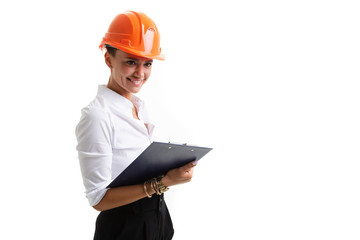 Beautiful caucasian female in office clothes write notes and holds an orange construction helmet isolated on white background