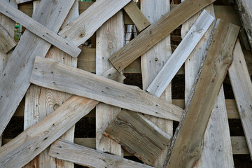 Construction jumble abstract background. Pile of boards scattered and mixed. Close-up.