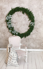 Elegant Interior with an armchair decorated for celebrating New Year. Comfort home in Christmas Holidays