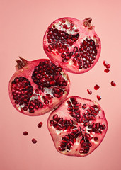 Close-Up Of Pomegranate Slices On Pink Background
