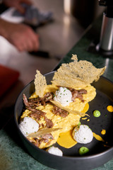 Dinner in restaurant. Pumpkin Risotto with with duck and parmesan cheese mousse. Seasonal autumnal recipe - risotto with organic pumpkins.
