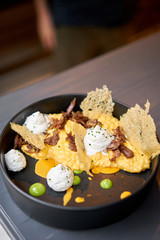 Dinner in restaurant. Pumpkin Risotto with with duck and parmesan cheese mousse. Seasonal autumnal recipe - risotto with organic pumpkins.