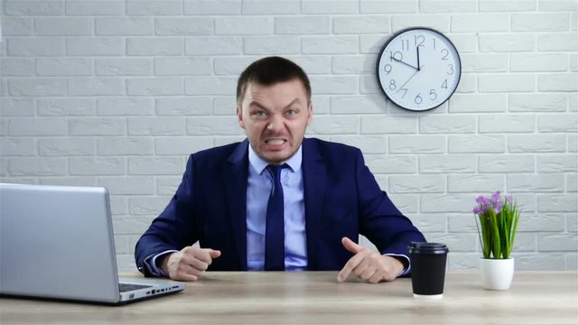 Angry businessman screaming. Aggressive boss threatens violence. Stress at work.