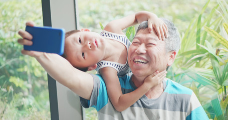 grandfather take selfie with kid - obrazy, fototapety, plakaty