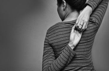 Asian woman exercising for shoulder stretching. Eagle Arms Asana. Posing for shoulder flexibility to relieve symptom of office syndrome. Black and white tone