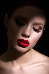 Close up portrait of a beautiful young model with bright evening make up, perfect skin and face in...