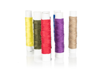 Group of six whole sewing thread spool isolated on white background