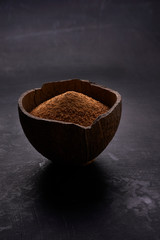 half of coconut's shell  with coconut sugar