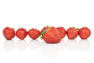 Lot of whole fresh red strawberry one in focus isolated on white background