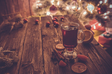 Christmas mulled wine on wooden table. Toned picture.