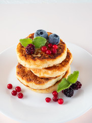 Healthy delicious Breakfast, homemade classic American pancakes with fresh berries, morning. Light background.