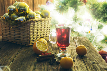 Christmas mulled wine on defocused christmas tree background.
