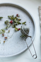 Herbal tea with dried raspberry and leaves on stone background with copy space