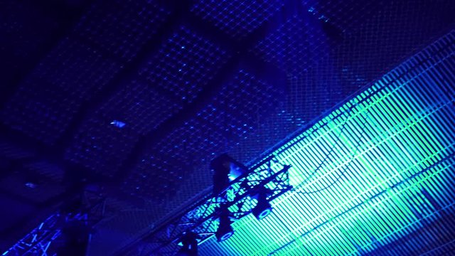 Ramp with lighting equipment. Blue spotlights on steel construction. Lightning equipment. The stage spotlights projecting lights during a live event. Live concerts and events. Stage lights