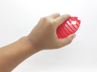 Hand Hold Artistic Red and Yellow Colored Bathroom Toilet Wash Brush with Animal Fish Shape in White Isolated Background