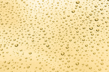 Water drops on a golden background, gold texture surface