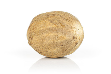 One whole dry brown nutmeg isolated on white background
