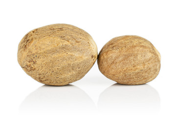 Group of two whole dry brown nutmeg isolated on white background
