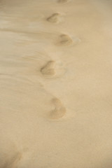 Fototapeta na wymiar Footprints reflected on the beach