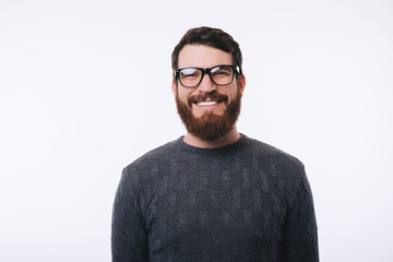 Portrait of young handsome man wearing eyeglasses smiling and looking confident at the camera