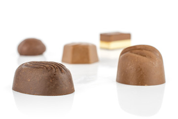 Group of five whole delicious chocolate praline isolated on white background