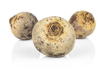 Group of three whole raw red beetroot isolated on white background