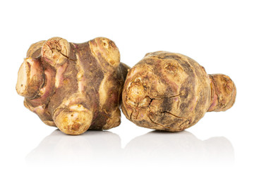 Group of two whole fresh brown jerusalem artichoke isolated on white background