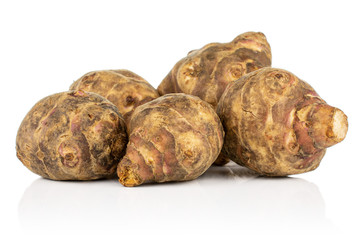 Group of five whole fresh brown jerusalem artichoke isolated on white background
