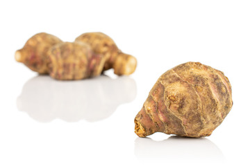 Group of four whole fresh brown jerusalem artichoke front focus isolated on white background