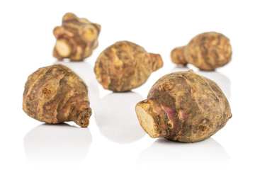 Group of five whole fresh brown jerusalem artichoke isolated on white background