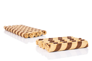 Lot of whole crunchy beige hazelnut rolled wafer biscuit isolated on white background