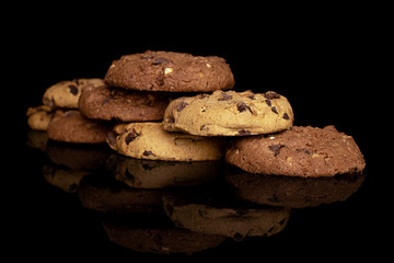 Group of eight whole sweet brown cookie isolated on black glass