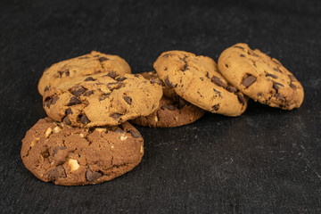 Group of six whole sweet brown cookie flatlay on grey stone