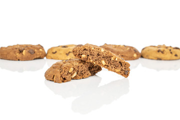 Group of four whole two halves of sweet brown cookie one cracked in focus isolated on white background