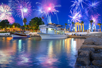 Fireworks display over the harbour with boats in Side, Turkey