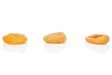 Group of three whole dried orange apricot isolated on white background