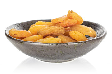 Lot of whole dried orange apricot in glazed bowl isolated on white background